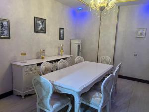a dining room with a white table and chairs at فندق رفايا الشاطيء in Jazan +20 photos