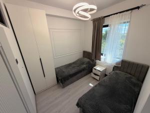 a small room with two beds and a window at MM House in Yerevan