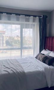 a bed in a bedroom with a window at KHomes Luxury Bed & Breakfast in Nairobi +12 photos