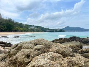 a beach with some rocks and the ocean at Sarona House 3 in Ban Thalat Choeng Thale