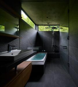 a bathroom with a tub and a sink and a shower at Seaside Villa SEEN Shallow Sea in Onomichi