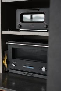 a toaster oven with a microwave on top of it at Seaside Villa SEEN Shallow Sea in Onomichi