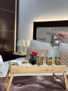 a coffee table with cups and a tea kettle on it at APARTAMENTOS ALBATROS in Asilah