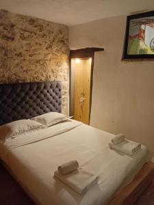 a bedroom with a large bed with towels on it at LE PANORAMIC- Sainte Agnès in Sainte-Agnès