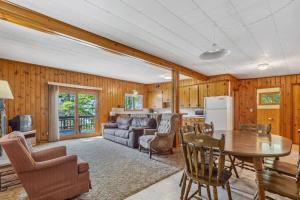 a living room with a table and a couch at Cabin #5 3BR 2BA Timberlane Resort in Park Rapids
