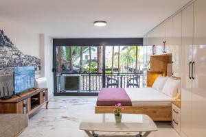 a hotel room with a bed and a balcony at Mirage Bay Deluxe in Sarandë