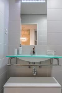 un baño con lavabo y espejo en Bracara Guest House "Arcada", en Braga