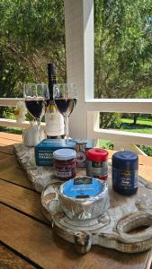 a table with two glasses of wine and a bottle at The Paddocks in Maleny +14 photos