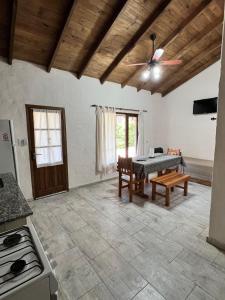 a living room with a table and a kitchen at Cabañas El Campo in Sierra de la Ventana +7 photos