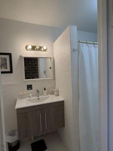 a bathroom with a sink and a shower at Verdun Beach, House in Montreal