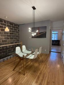 a dining room with a table and white chairs at Verdun Beach, House in Montreal +18 photos