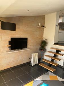 a living room with a wall with a flat screen tv at LE PANORAMIC- Sainte Agnès in Sainte-Agnès