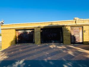 a building with two garage doors on it at Khomasdal B&B in Windhoek