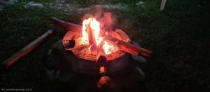 a fire pit with flames in the grass at Bungalows Payancas de Tato in Barranca