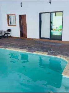 a swimming pool in a house with blue water at Khomasdal B&B in Windhoek