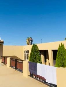 a large building with trees in front of it at Khomasdal B&B in Windhoek +3 photos