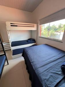 a bedroom with two bunk beds and a window at Recanto Tranquilo - Espaço amplo e completo - Sky in São Luís +45 photos