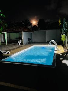a swimming pool at night with a swimming pooliterator at Recanto Tranquilo - Espaço amplo e completo - Sky in São Luís