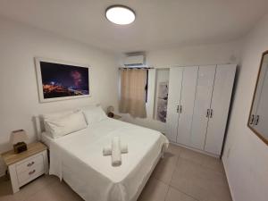 a bedroom with a bed with a cross on it at Lev Eilat Suites in Eilat