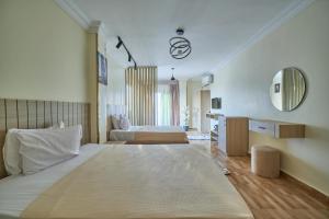 a large room with two beds and a mirror at Magic pyramids star hotel in Cairo