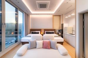 a hotel room with two beds and a couch at STAY On-A in Seoul
