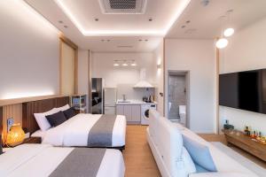 a hotel room with two beds and a kitchen at STAY On-A in Seoul