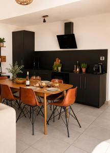 a kitchen with a wooden table and chairs at Oasis Blue Perpignan Canet in Perpignan