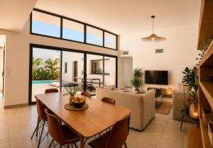 an open living room with a table and a couch at Oasis Blue Perpignan Canet in Perpignan
