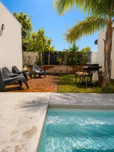 a backyard with a pool and a table and chairs at Oasis Blue Perpignan Canet in Perpignan