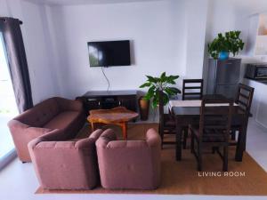 a living room with a couch and a table at The Clifftop Home Deluxe in Esperanza