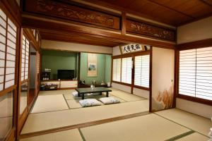 a japanese room with a table in the middle at Sane Yanagisawa in Awaji