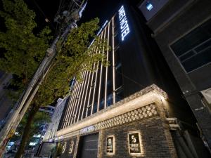 a building with a sign on the side of it at 대구 동천 스위트 호텔 in Daegu