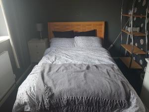 a bedroom with a large bed with a wooden headboard at Shephall Zoo in Shephall