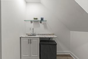 a kitchen with a sink and a shelf on the wall at Modern 3BR Home Patio Near Center City Free Parkin in Philadelphia