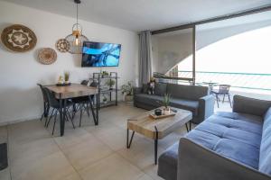 a living room with a couch and a table at Lev Eilat Suites in Eilat