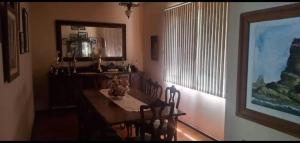 a dining room with a table and some chairs at Suíte Pimenteiras in Teresópolis