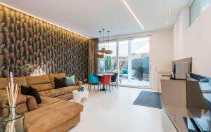 a living room with a couch and a table at Merangardenvilla adults only in Merano
