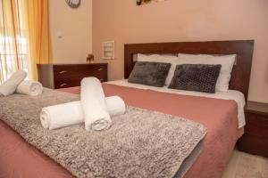 a bedroom with a bed with towels on it at Stylida Apartment - Ocean Air & Quiet Nights! in Stilís +20 photos
