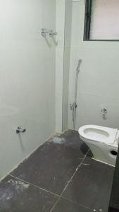 a bathroom with a toilet and a shower stall at Munot residency in Manmād