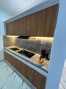 a kitchen with a sink and a counter top at MEDEWI BREEZE House in Airsatang