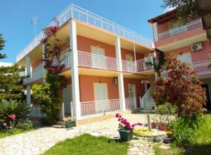 a large apartment building with balconies and flowers at Angelos aparts in Arillas