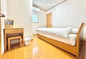 a small bedroom with a bed and a fireplace at Casa2 in Katsura +83 photos