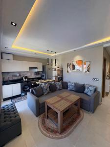 a living room with a couch and a table at New Luxury apartment with 3 pool in Cabo Negro