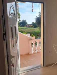 an open door with a view of a patio at Angelos aparts in Arillas