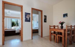 a dining room with a table and a mirror at Angelos aparts in Arillas