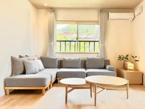 a living room with a couch and a table at Casa2 in Katsura