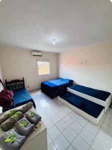 a room with two beds and a couch in it at Suíte com ampla área externa - Pink in São Luís