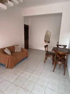 a bedroom with a bed and a table and chairs at Suíte com ampla área externa - Pink in São Luís +35 photos