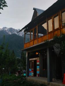 a building with a balcony with mountains in the background at The North Rememberzz in Kalgha
