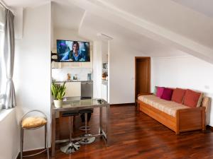 a living room with a couch and a table at Sweets Suites Espinho in Espinho
